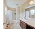 Bright bathroom featuring a shower-tub combo, vanity with sink, and ample lighting at 5768 Blue Sky Dr, Whitestown, IN 46075
