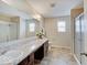 Bright bathroom with dual sinks, a large mirror, and a glass-enclosed shower at 5768 Blue Sky Dr, Whitestown, IN 46075