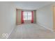 Expansive bedroom with plush carpet and bright window with red curtains at 5768 Blue Sky Dr, Whitestown, IN 46075
