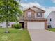 Charming two-story home with brick accents, a well-maintained lawn, and a two-car garage at 5768 Blue Sky Dr, Whitestown, IN 46075