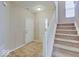 Bright foyer featuring tile flooring, a front door, and staircase to the upper level at 5768 Blue Sky Dr, Whitestown, IN 46075