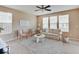Cozy living room with ample natural light, plush carpeting, and comfortable seating arrangement at 5768 Blue Sky Dr, Whitestown, IN 46075