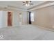 Large main bedroom with neutral carpet, ceiling fan, and doorways to a closet and bathroom at 5768 Blue Sky Dr, Whitestown, IN 46075