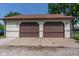 Spacious two-car garage with brown doors, offering ample parking and storage space with easy access at 60 S 8Th Ave, Beech Grove, IN 46107