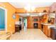 Bright kitchen featuring tile floors, wooden cabinets and modern appliances at 60 S 8Th Ave, Beech Grove, IN 46107