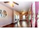 Spacious living room featuring hardwood floors, ceiling fan, fresh paint, natural light and ornate mirror at 60 S 8Th Ave, Beech Grove, IN 46107