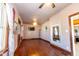 Spacious living room with hardwood floors, ceiling fan, fresh paint, natural light and ornate mirror at 60 S 8Th Ave, Beech Grove, IN 46107
