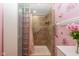 Bathroom shower with tile surround, pink curtain and glass block accent wall at 60 S 8Th Ave, Beech Grove, IN 46107