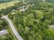 Serene aerial view of the neighborhood showcasing lush trees, and winding streets at 6363 Harmonridge Ct, Indianapolis, IN 46278