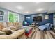 Finished basement featuring wood look floors, comfortable seating, and TV at 6363 Harmonridge Ct, Indianapolis, IN 46278