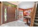 Inviting entryway with wood door, decorative glass and hardwood floors, leading to dining room at 6363 Harmonridge Ct, Indianapolis, IN 46278