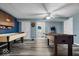 Spacious game room has a ceiling fan, a shuffle board table, and a foosball table at 6363 Harmonridge Ct, Indianapolis, IN 46278