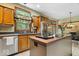 Modern kitchen with stainless steel appliances, island cooktop, and breakfast bar seating at 6363 Harmonridge Ct, Indianapolis, IN 46278