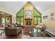 Inviting living room featuring a cozy fireplace, hardwood floors, and plenty of natural light at 6363 Harmonridge Ct, Indianapolis, IN 46278