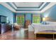 Spacious main bedroom featuring wood floors, tray ceiling, sitting area and natural light at 6363 Harmonridge Ct, Indianapolis, IN 46278