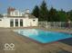Sparkling outdoor pool with lounge chairs and a nearby clubhouse for relaxation and recreation at 6363 Harmonridge Ct, Indianapolis, IN 46278