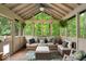 Relaxing sunroom with wooded view, ceiling fan, comfortable seating and natural light at 6363 Harmonridge Ct, Indianapolis, IN 46278