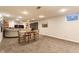Finished basement featuring a grey sofa, game table, and a small window offering natural light at 6455 N Olney St, Indianapolis, IN 46220