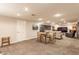 Spacious carpeted basement featuring a seating area, a game table, and a door to the outside at 6455 N Olney St, Indianapolis, IN 46220