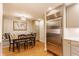 Kitchen and dining area showing a large stainless steel refrigerator and cozy dining space with seating and décor at 6455 N Olney St, Indianapolis, IN 46220