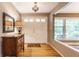 Bright foyer featuring hardwood floors, a stylish mirror, and a double door entry at 6455 N Olney St, Indianapolis, IN 46220