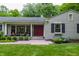 Close-up of front porch with red front door and well-manicured bushes at 6455 N Olney St, Indianapolis, IN 46220
