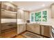Updated kitchen featuring a large stainless steel refrigerator, ample counter space, and lots of cabinet space for storage at 6455 N Olney St, Indianapolis, IN 46220