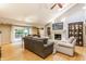 Inviting living room featuring a fireplace, built-in shelving, and hardwood floors at 6455 N Olney St, Indianapolis, IN 46220