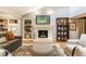 Cozy living room area with a fireplace, decor, and hardwood floors at 6455 N Olney St, Indianapolis, IN 46220