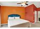 Stylish bedroom featuring vibrant accent walls and a comfortable bed with a plush, blue headboard at 6518 Jade Stream Ct # 312, Indianapolis, IN 46237