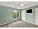 Bedroom featuring a ceiling fan, carpet and bright window with nature view at 6518 Jade Stream Ct # 312, Indianapolis, IN 46237
