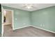 Spacious bedroom with a ceiling fan, carpet and access to the kitchen at 6518 Jade Stream Ct # 312, Indianapolis, IN 46237