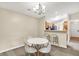 Open dining area features a modern chandelier and seating for four at 6518 Jade Stream Ct # 312, Indianapolis, IN 46237