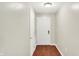 Hallway with access to unit entrance with wooden floors and painted white walls at 6518 Jade Stream Ct # 312, Indianapolis, IN 46237