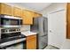 Efficient kitchen with stainless steel appliances and ample counter space at 6518 Jade Stream Ct # 312, Indianapolis, IN 46237