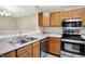 Well-equipped kitchen with modern stainless steel appliances and a view of the dining area at 6518 Jade Stream Ct # 312, Indianapolis, IN 46237
