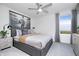 Neutral bedroom features a gray bed, gray curtains and light wood nightstand at 6841 Seabiscuit Rd, Whitestown, IN 46075