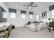 Bright living room features contemporary decor, neutral sectional, and three windows dressed with dark gray shades at 6841 Seabiscuit Rd, Whitestown, IN 46075