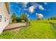 Lush backyard with a well-maintained deck ideal for outdoor enjoyment and gatherings at 705 Treyburn Lakes Way, Indianapolis, IN 46239