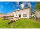 View of a house with a large backyard featuring a wooden deck perfect for outdoor entertaining and relaxation at 705 Treyburn Lakes Way, Indianapolis, IN 46239