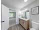 Bathroom featuring double vanity, stylish mirrors, and contemporary fixtures at 705 Treyburn Lakes Way, Indianapolis, IN 46239