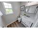 Bathroom featuring a vanity, toilet, stylish mirror, and a bright window at 705 Treyburn Lakes Way, Indianapolis, IN 46239