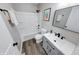 Modern bathroom featuring a white vanity, sleek black fixtures, and a combined tub and shower at 705 Treyburn Lakes Way, Indianapolis, IN 46239