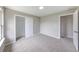 Bright bedroom with neutral walls, carpet, a closet, and an entrance to another room at 705 Treyburn Lakes Way, Indianapolis, IN 46239
