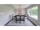 Bright dining room with large window, modern lighting, neutral walls, and hardwood floors at 705 Treyburn Lakes Way, Indianapolis, IN 46239