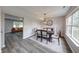 Elegant dining room with stylish lighting fixture, large window, and access to the living room at 705 Treyburn Lakes Way, Indianapolis, IN 46239