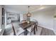 Charming dining area with modern lighting fixture, adjacent to the kitchen, and a slider to the deck at 705 Treyburn Lakes Way, Indianapolis, IN 46239