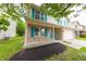 This cozy two-story home features a brick accent, teal shutters, covered porch, and well-maintained landscaping at 705 Treyburn Lakes Way, Indianapolis, IN 46239