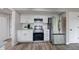 Modern kitchen featuring stainless steel appliances, white cabinetry, and stylish countertops at 705 Treyburn Lakes Way, Indianapolis, IN 46239
