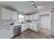Bright kitchen with stainless steel appliances, white cabinets, and wood-look floors at 705 Treyburn Lakes Way, Indianapolis, IN 46239